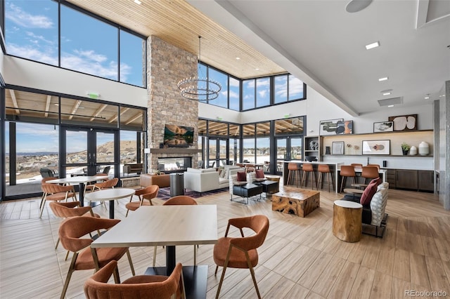 624 Simmental Loop, Castle Rock, CO 80104 - dining space with a high ceiling and a stone fireplace