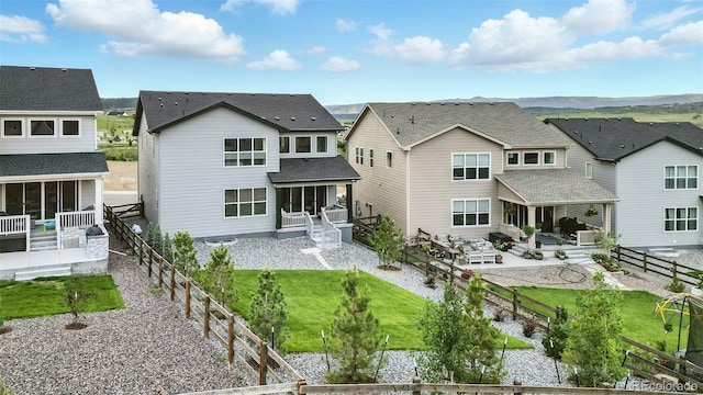 624 Simmental Loop, Castle Rock, CO 80104 - back of house featuring a sunroom, a residential view, a patio area, and a fenced backyard