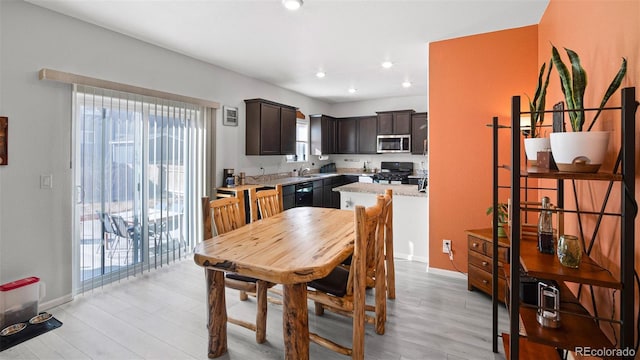 dining space featuring recessed lighting, baseboards, and light wood-style floors