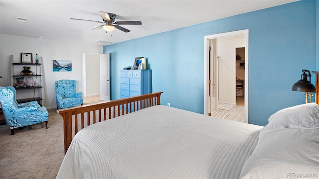 bedroom featuring ceiling fan, visible vents, and light carpet