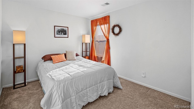 carpeted bedroom featuring visible vents and baseboards