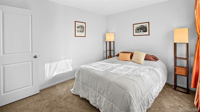 bedroom featuring carpet flooring and baseboards