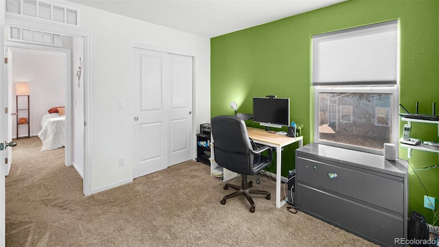 office space featuring visible vents, baseboards, and carpet