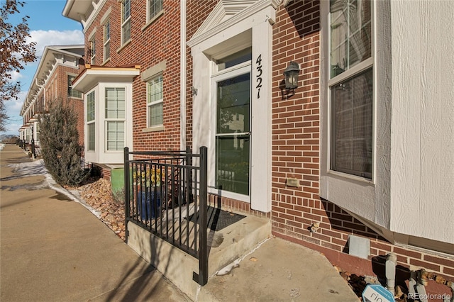 property entrance with brick siding