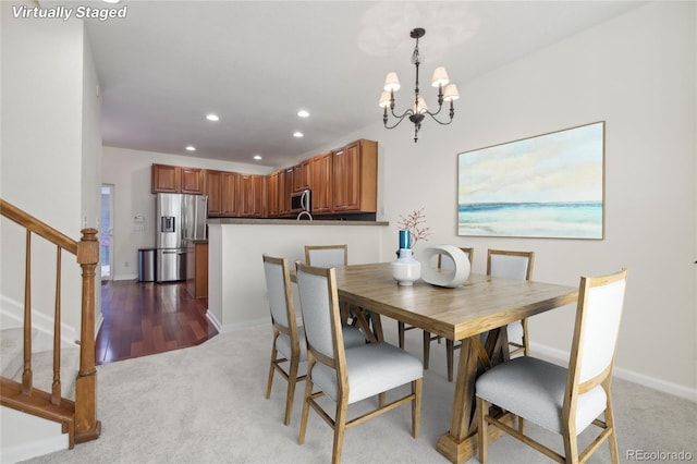 carpeted dining space featuring a chandelier