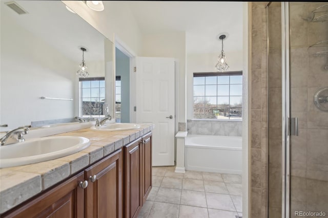 bathroom with tile patterned flooring, visible vents, a sink, and a shower stall