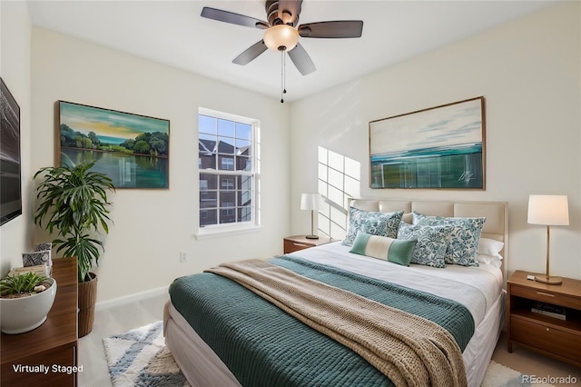 carpeted bedroom featuring ceiling fan and baseboards