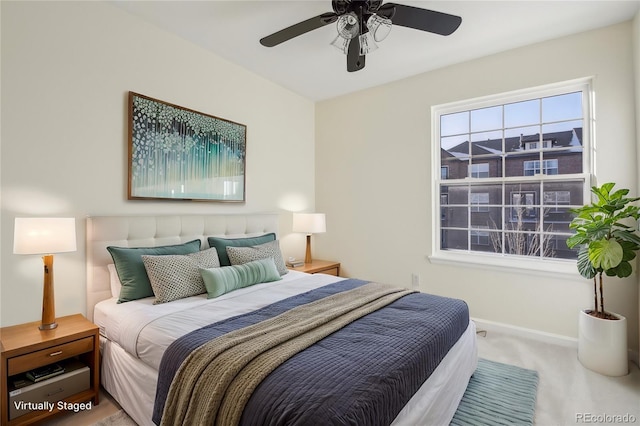 carpeted bedroom featuring a ceiling fan and baseboards