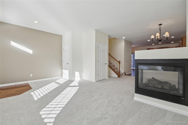 living area featuring light carpet, stairway, an inviting chandelier, and baseboards