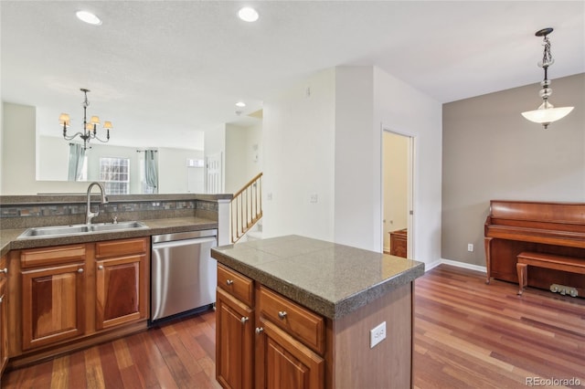 kitchen featuring recessed lighting, stainless steel dishwasher, dark wood-type flooring, brown cabinetry, and a sink