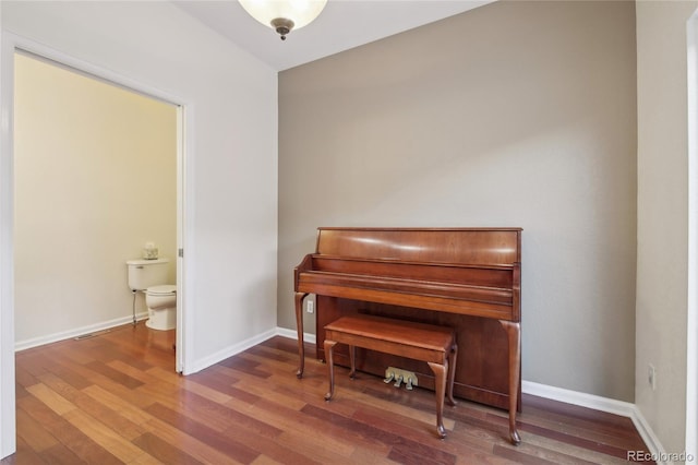 sitting room with wood finished floors and baseboards