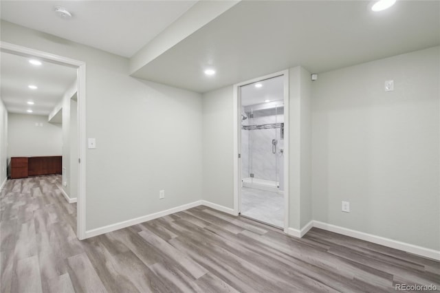 finished below grade area featuring baseboards, wood finished floors, and recessed lighting