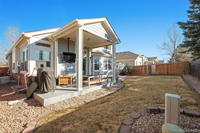 exterior space featuring a patio area, a fenced backyard, and a yard