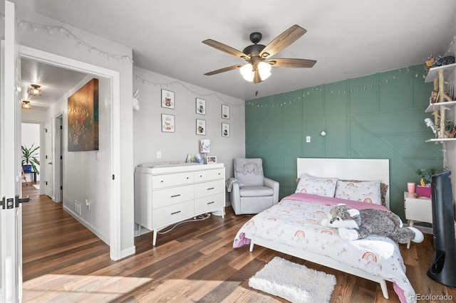 bedroom with a ceiling fan and wood finished floors