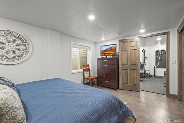 bedroom featuring recessed lighting and concrete floors