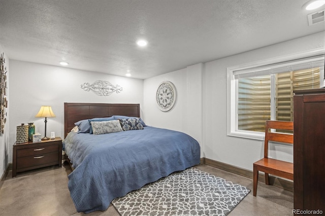 bedroom with baseboards, visible vents, a textured ceiling, concrete floors, and recessed lighting