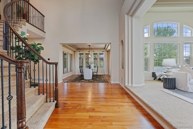 7408 Sodalite Way, Castle Rock, CO 80108 - foyer with a high ceiling, plenty of natural light, wood finished floors, stairway, and baseboards