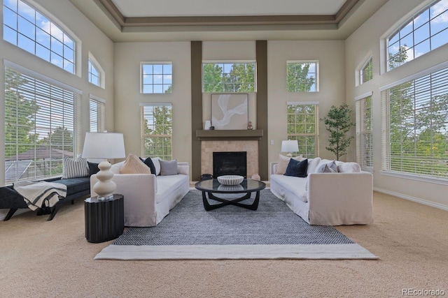 7408 Sodalite Way, Castle Rock, CO 80108 - carpeted living room featuring a high ceiling, a fireplace, a raised ceiling, and baseboards