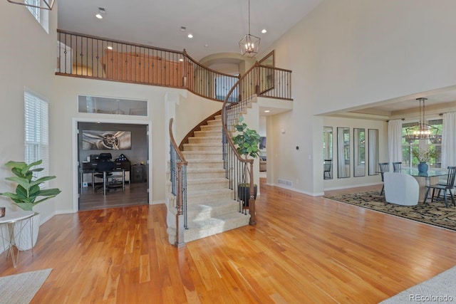 7408 Sodalite Way, Castle Rock, CO 80108 - entryway with a chandelier, wood finished floors, stairs, a high ceiling, and recessed lighting