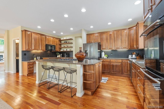 7408 Sodalite Way, Castle Rock, CO 80108 - kitchen with open shelves, stainless steel fridge with ice dispenser, black microwave, a kitchen island, and recessed lighting