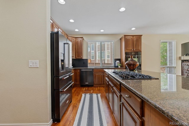 7408 Sodalite Way, Castle Rock, CO 80108 - kitchen featuring appliances with stainless steel finishes, healthy amount of natural light, wood finished floors, a sink, and recessed lighting