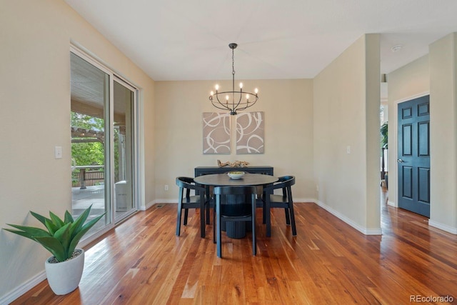 7408 Sodalite Way, Castle Rock, CO 80108 - dining space featuring a chandelier, light wood-type flooring, and baseboards