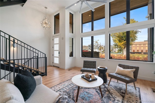 living room with baseboards, wood finished floors, and a wealth of natural light