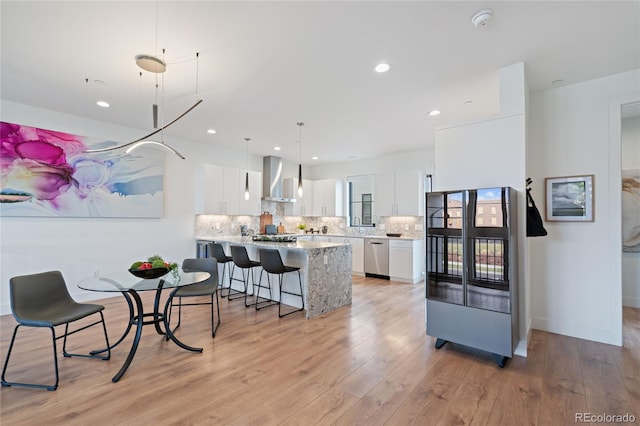 dining area featuring light wood-type flooring and recessed lighting