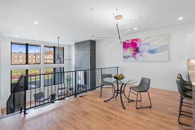 dining space with baseboards, recessed lighting, and wood finished floors