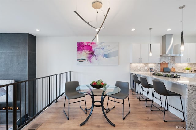 dining space featuring recessed lighting, light wood-type flooring, and visible vents