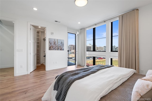 bedroom featuring baseboards, recessed lighting, light wood-style flooring, and visible vents
