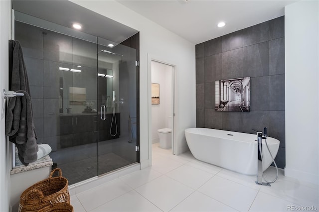 full bath with tile patterned flooring, a freestanding tub, tile walls, recessed lighting, and a stall shower