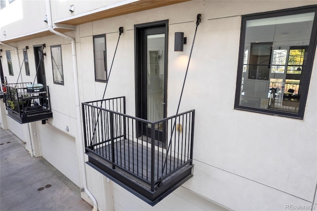 entrance to property featuring stucco siding