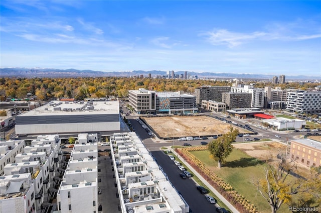 drone / aerial view featuring a city view and a mountain view