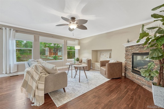 123 Wheat Ridge St, Palmer Lake, CO 80133 - living area featuring crown molding, hardwood / wood-style flooring, healthy amount of natural light, a ceiling fan, and a fireplace
