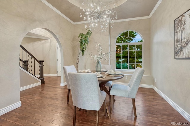 123 Wheat Ridge St, Palmer Lake, CO 80133 - dining area featuring hardwood / wood-style floors, arched walkways, a chandelier, stairway, and a textured wall