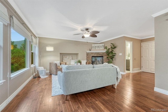 123 Wheat Ridge St, Palmer Lake, CO 80133 - living room featuring a ceiling fan, dark wood finished floors, crown molding, and a stone fireplace
