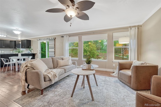 123 Wheat Ridge St, Palmer Lake, CO 80133 - living room with light wood-style floors, crown molding, and ceiling fan