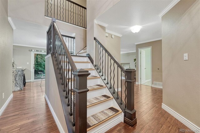123 Wheat Ridge St, Palmer Lake, CO 80133 - stairway with ornamental molding and wood finished floors