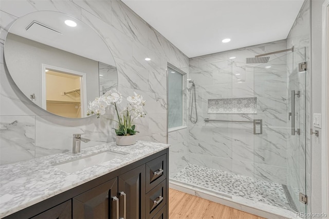 123 Wheat Ridge St, Palmer Lake, CO 80133 - bathroom featuring vanity, a marble finish shower, and recessed lighting