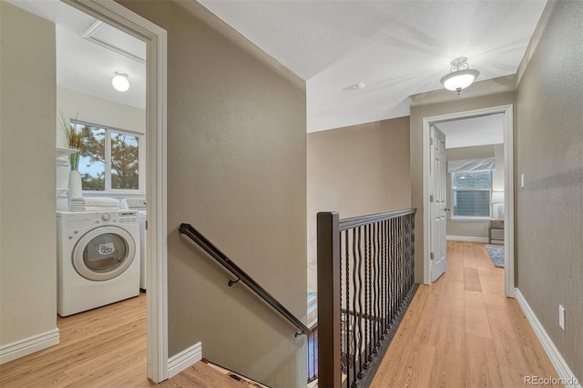 123 Wheat Ridge St, Palmer Lake, CO 80133 - hallway featuring an upstairs landing, light wood-style floors, a textured wall, and separate washer and dryer