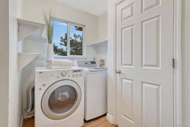 123 Wheat Ridge St, Palmer Lake, CO 80133 - washroom with washing machine and dryer and light wood-style floors