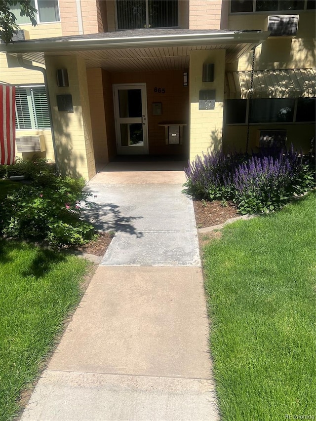 665 S Clinton St Unit 14A, Denver, CO 80247 - view of exterior entry featuring brick siding