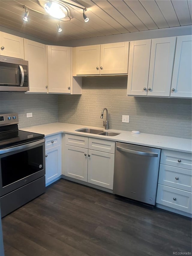 665 S Clinton St Unit 14A, Denver, CO 80247 - kitchen featuring stainless steel appliances, a sink, light countertops, track lighting, and tasteful backsplash