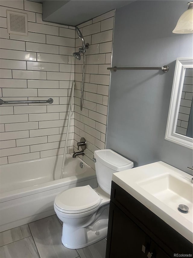 665 S Clinton St Unit 14A, Denver, CO 80247 - bathroom featuring vanity, toilet, and bathing tub / shower combination