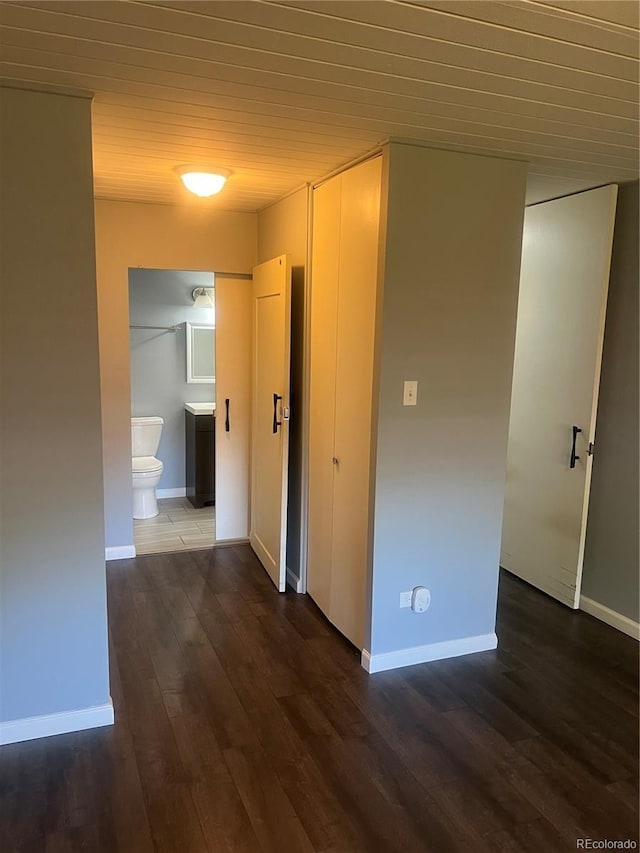 665 S Clinton St Unit 14A, Denver, CO 80247 - corridor featuring wooden ceiling, dark wood-style floors, and baseboards