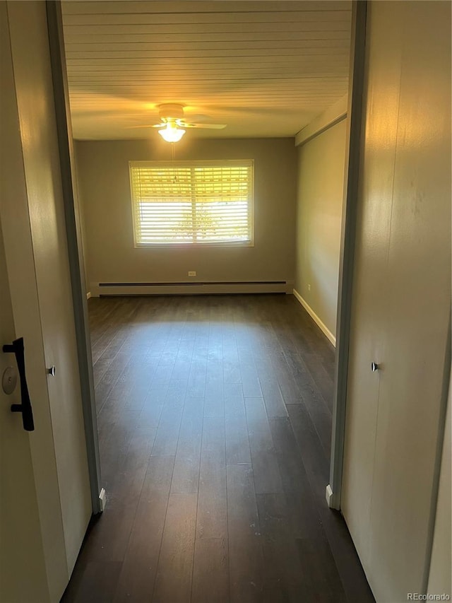 665 S Clinton St Unit 14A, Denver, CO 80247 - empty room with dark wood-type flooring, a ceiling fan, wooden ceiling, baseboards, and a baseboard heating unit