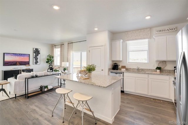 kitchen featuring white cabinetry, light stone countertops, and stainless steel appliances