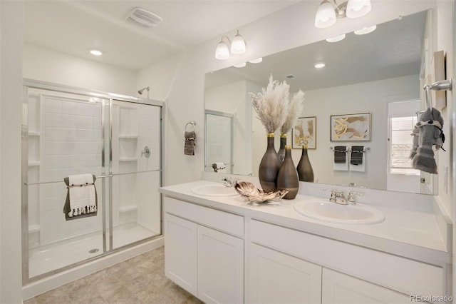 bathroom with vanity and a shower with door