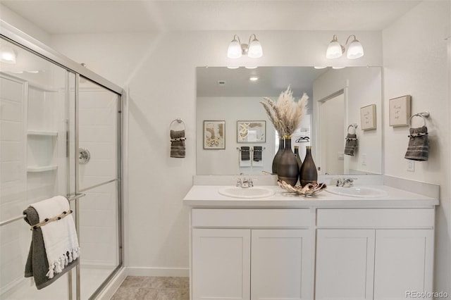 bathroom featuring vanity, tile patterned flooring, and a shower with door